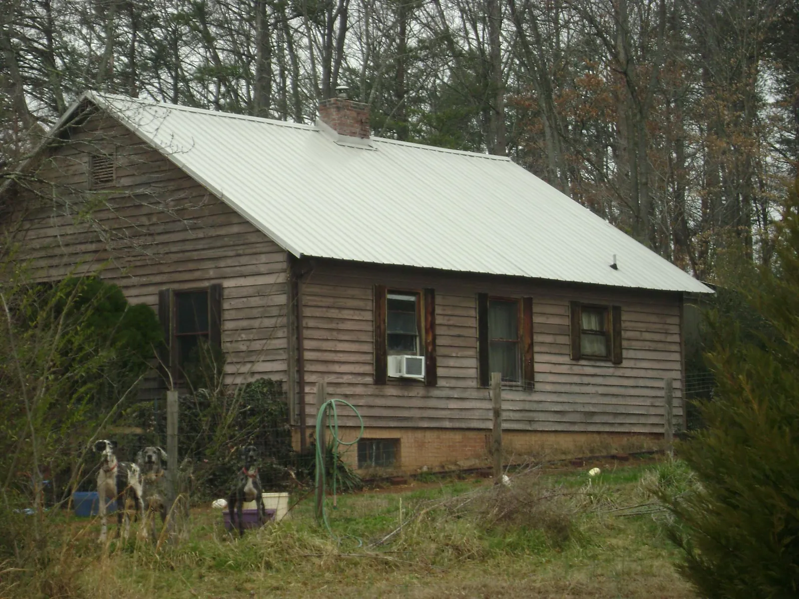 White metal roof on an old wood sided farmhouse, from a Metal Roof Installation job in Litchfield